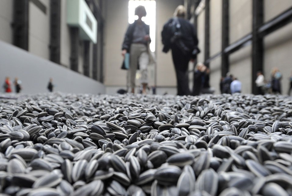 Visitors-walk-through-the-art-installation-Sunflower-Seeds-by-Chinese-artist-Ai-Weiwei-in-London.jpg