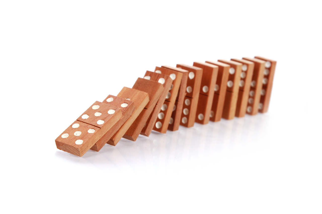 closeup-wooden-dominoes-falling-white-surface.jpg