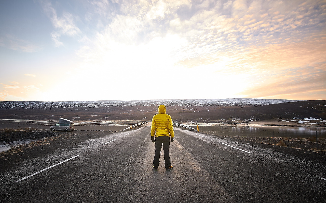 male-wearing-yellow-jacket-while-standing-middle-empty-road-looking-distance.jpg