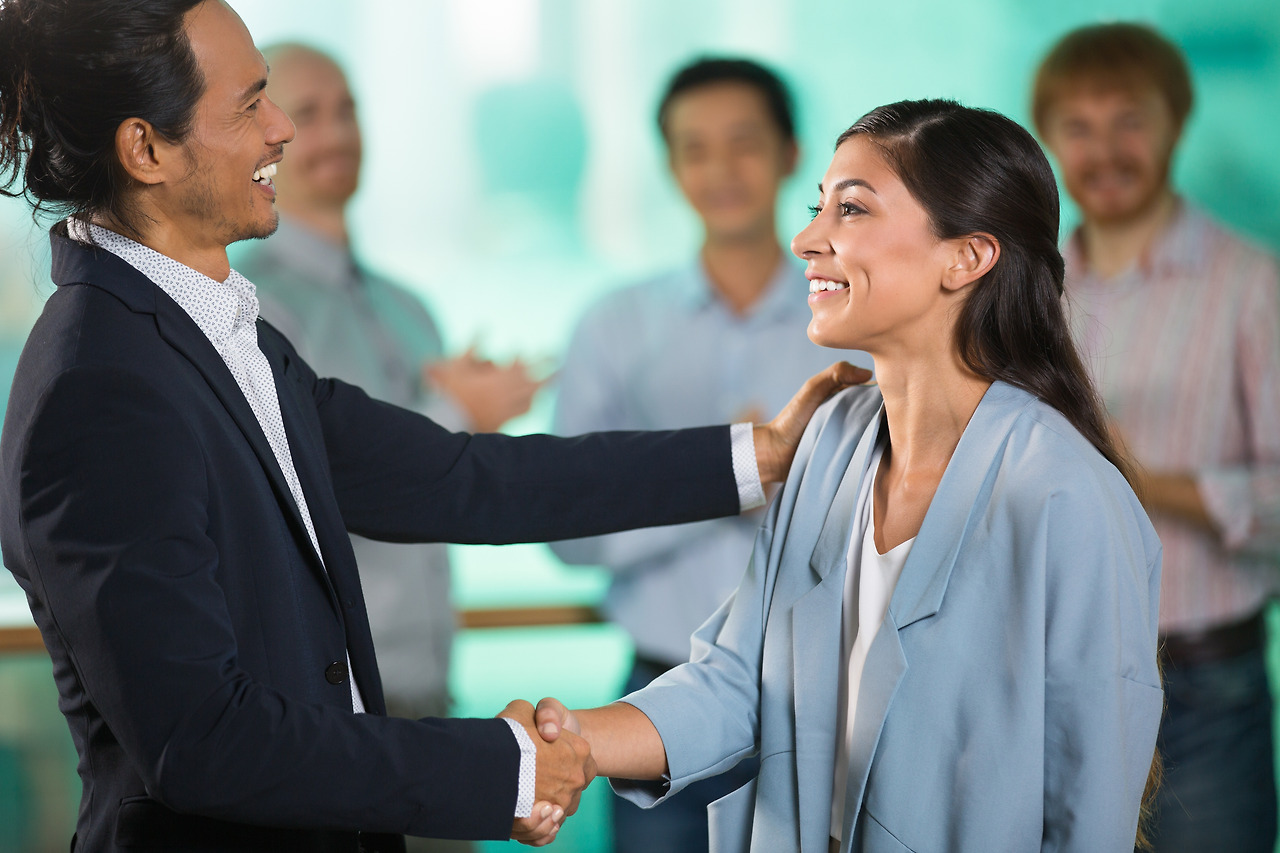 smiling-middle-aged-business-people-shaking-hands.jpg