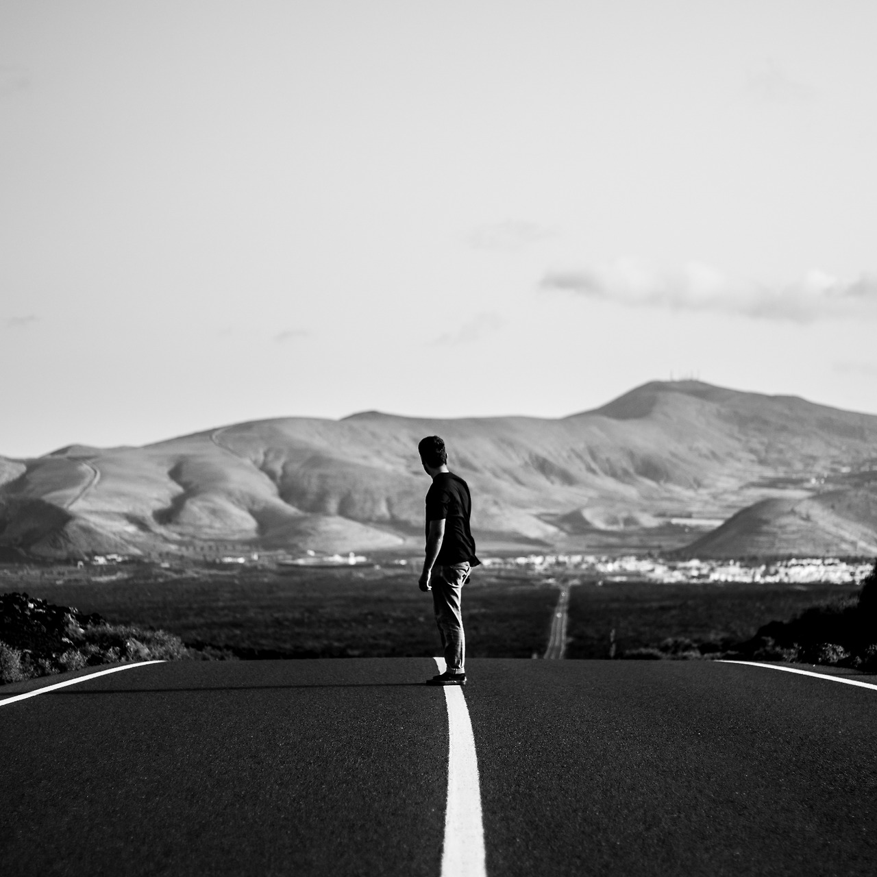 man-skateboarder-riding-empty-highway-road-with-amazing-hills.jpg