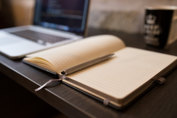 notebook-and-ballpoint-with-laptop-in-background.jpg