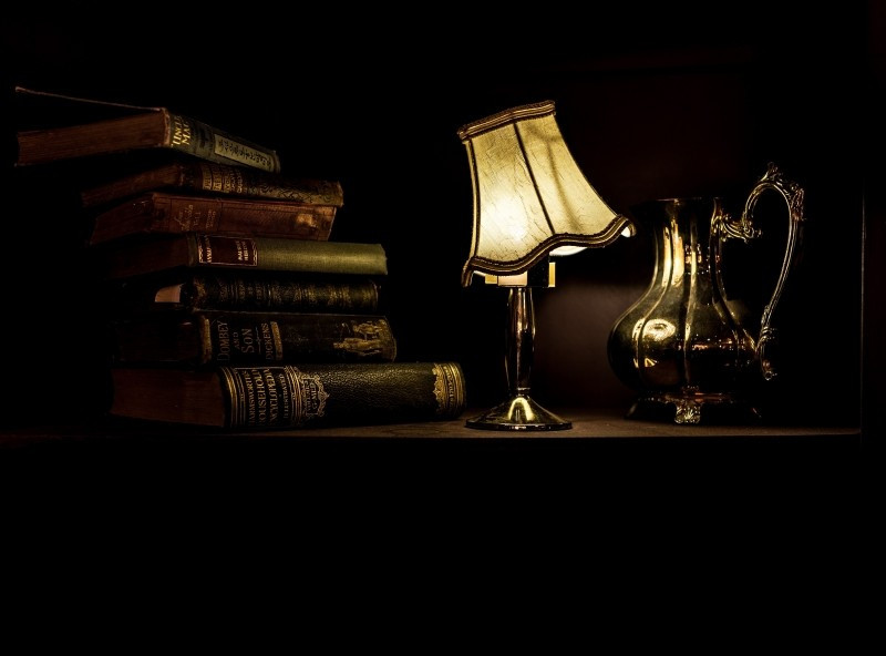 ancient-lamp-with-silver-jug-and-books-on-table.jpg
