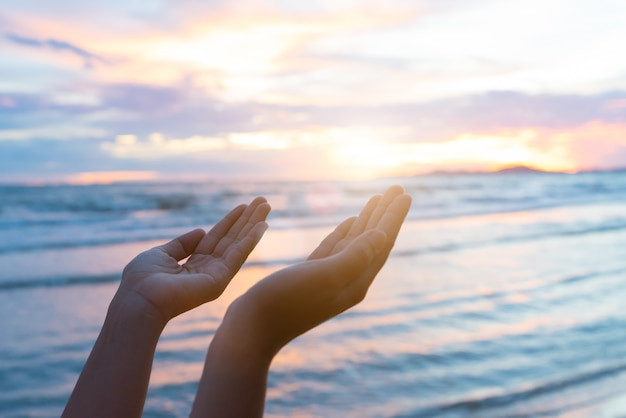 woman-hands-praying-for-blessing-from-god-during-sunset-background-hope-concept_53476-1422.jpg