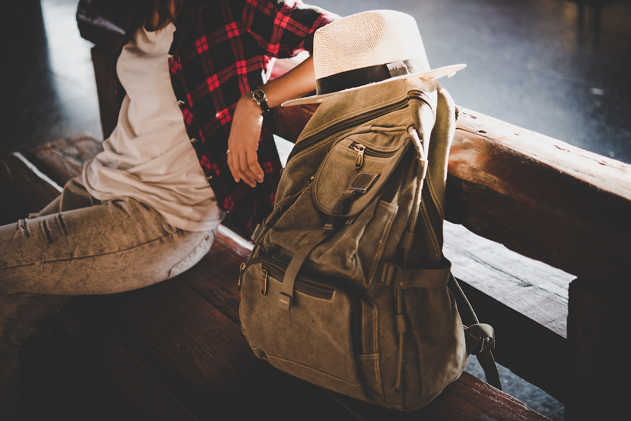 young-hipster-tourist-woman-with-backpack-sitting-train-station-holiday-tourist-concept.jpg
