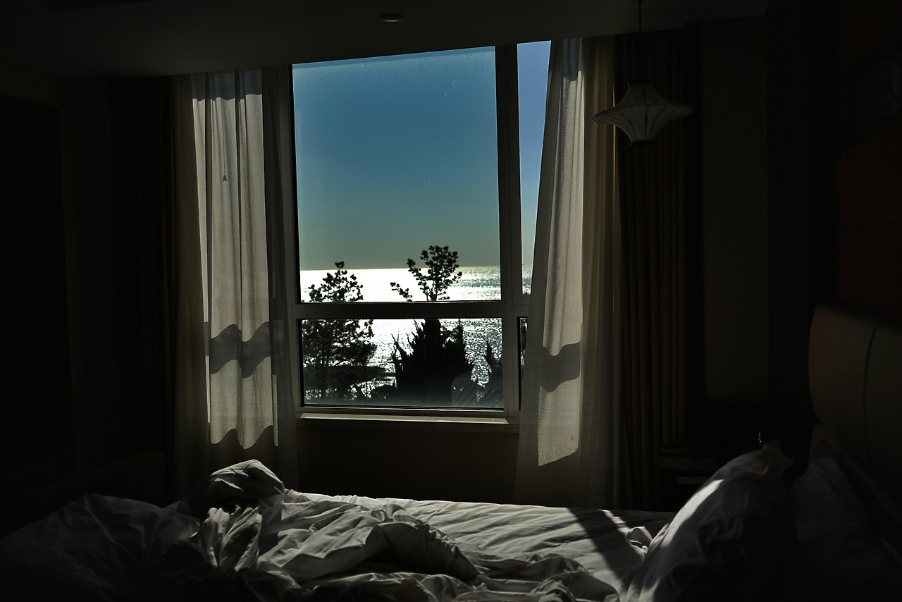 view-sea-through-open-window-bedroom.jpg