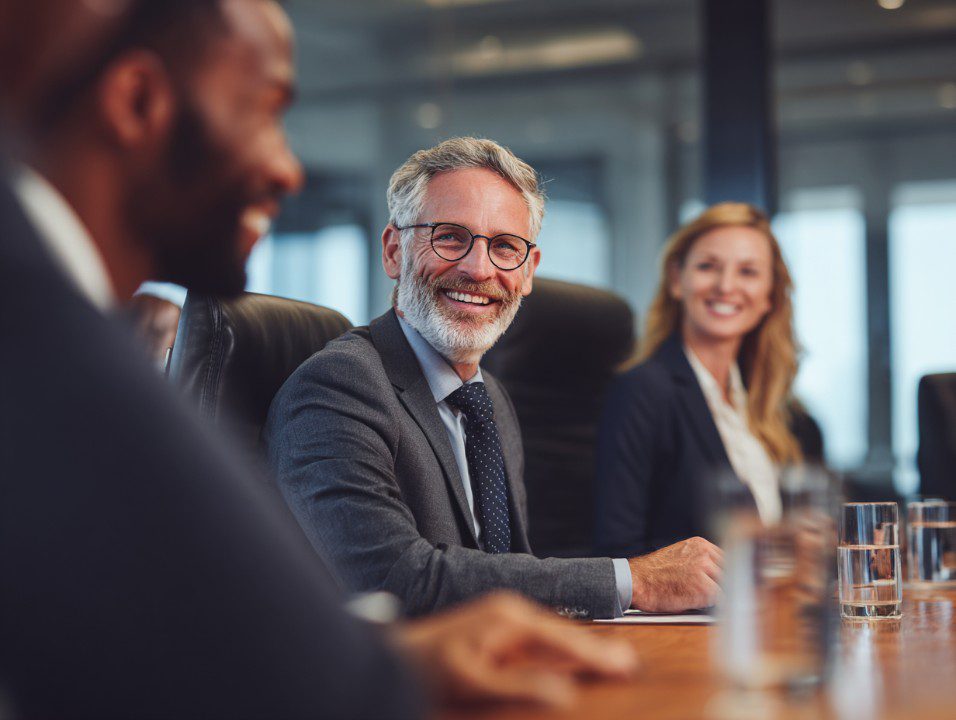 smiling-business-team-in-meeting-room.jpg