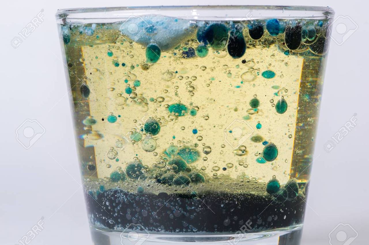 74190774-glass-with-drops-of-colored-bubbles-in-water-and-oil.jpg