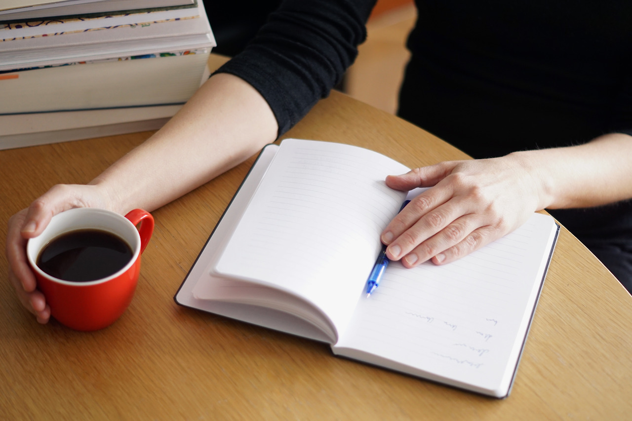 closeup-shot-woman-working-studying-from-home-with-red-coffee-her-hand.jpg