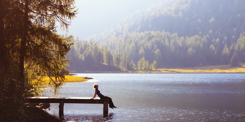 woman-relaxing-mountain-lake.png