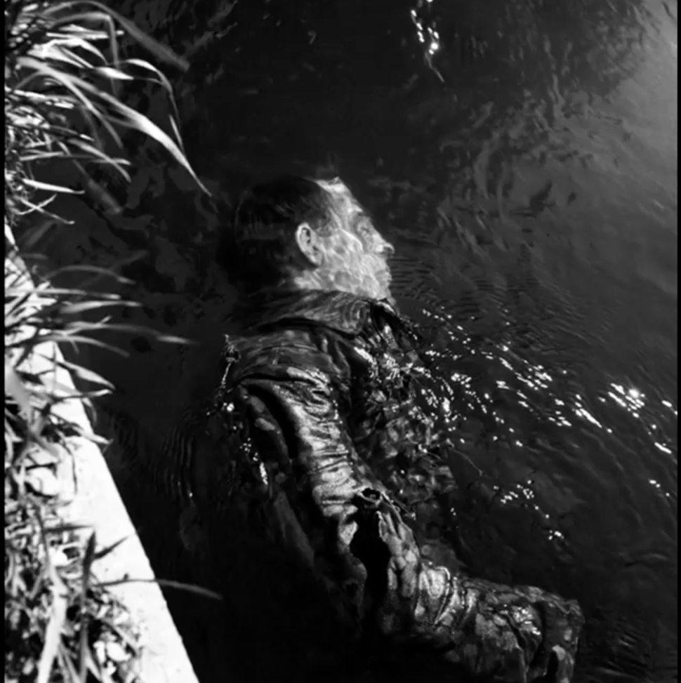 Lee Miller, Dead SS Guard in Canal, Dachau, Germany, 1945.png
