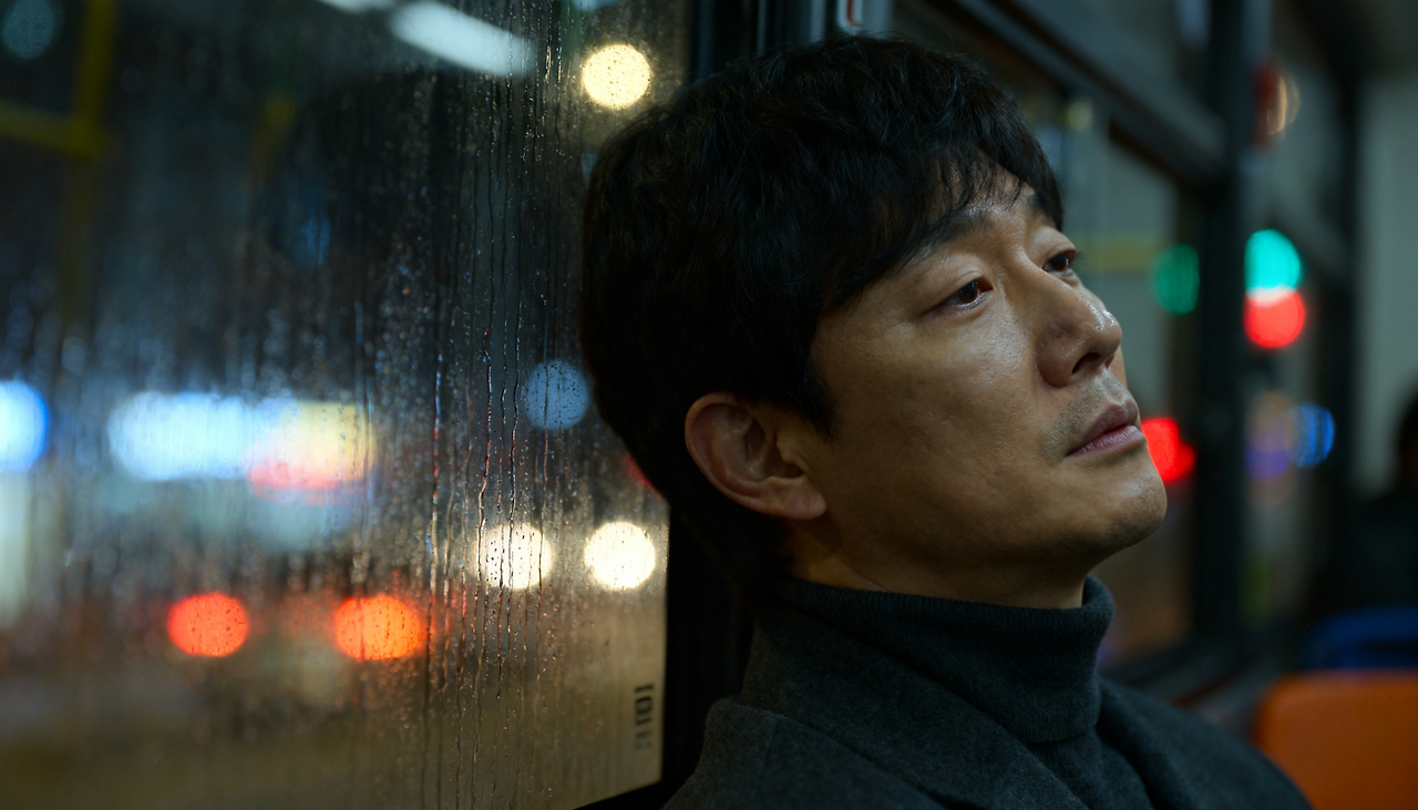 freepik__contemplative-korean-man-late-30s-in-muted-charcoa__36613.png