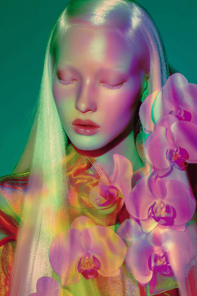 stylejung2_glowing_orchid_projections_cast_on_models_face_and_c_a1369362-3ae2-43fe-8f55-852e3904b3c3.png