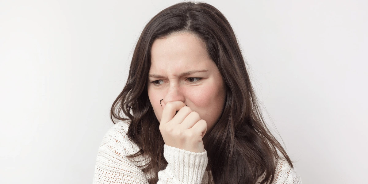 What-makes-cat-litter-so_smelly-Woman-holding-nose.png?v=1692392012