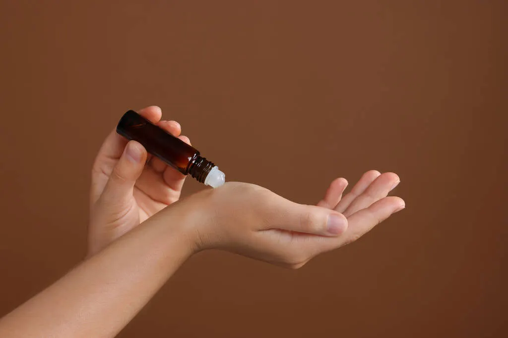 stock-photo-woman-roller-bottle-applying-essential-oil-wrist-brown-background-closeup_fe0f04a7-dddf-4c9a-9351-84f2cd9f1de2.jpg?v=1747064643
