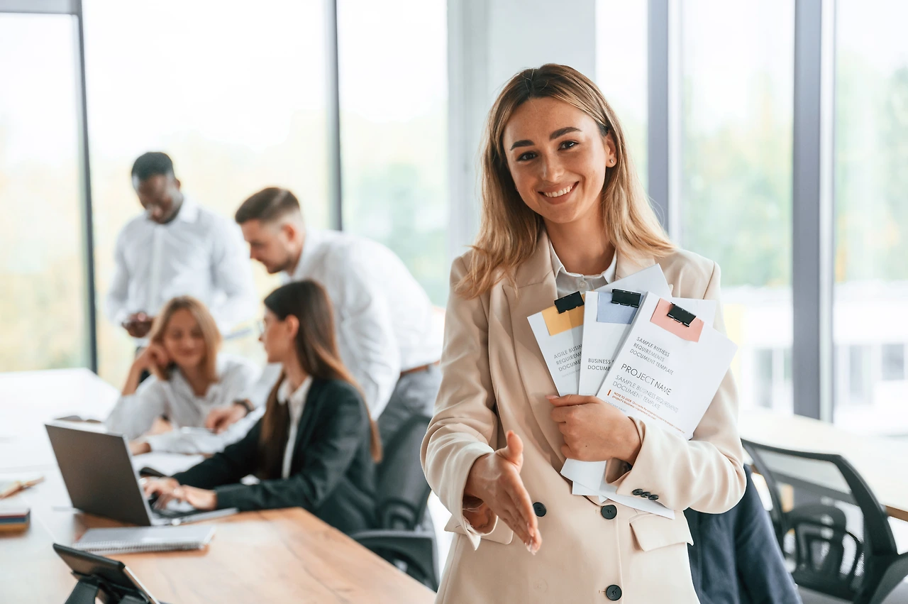 young-woman-is-holding-documents-in-hands-standin-2023-11-29-17-18-59-utc.JPG