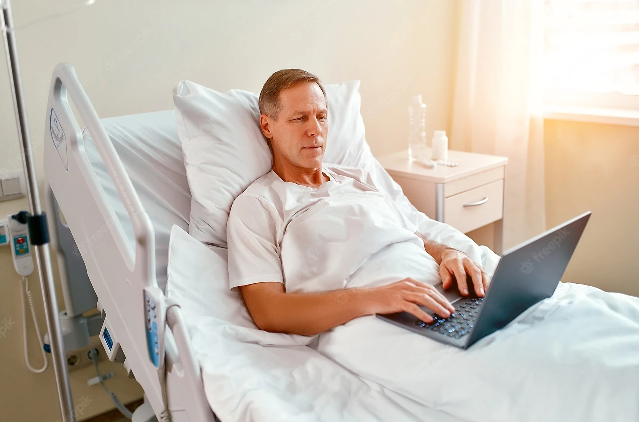 mature-caucasian-male-patient-using-laptop-bed-hospital-working-even-when-sick-hospital_189498-976.jpg?w=2000