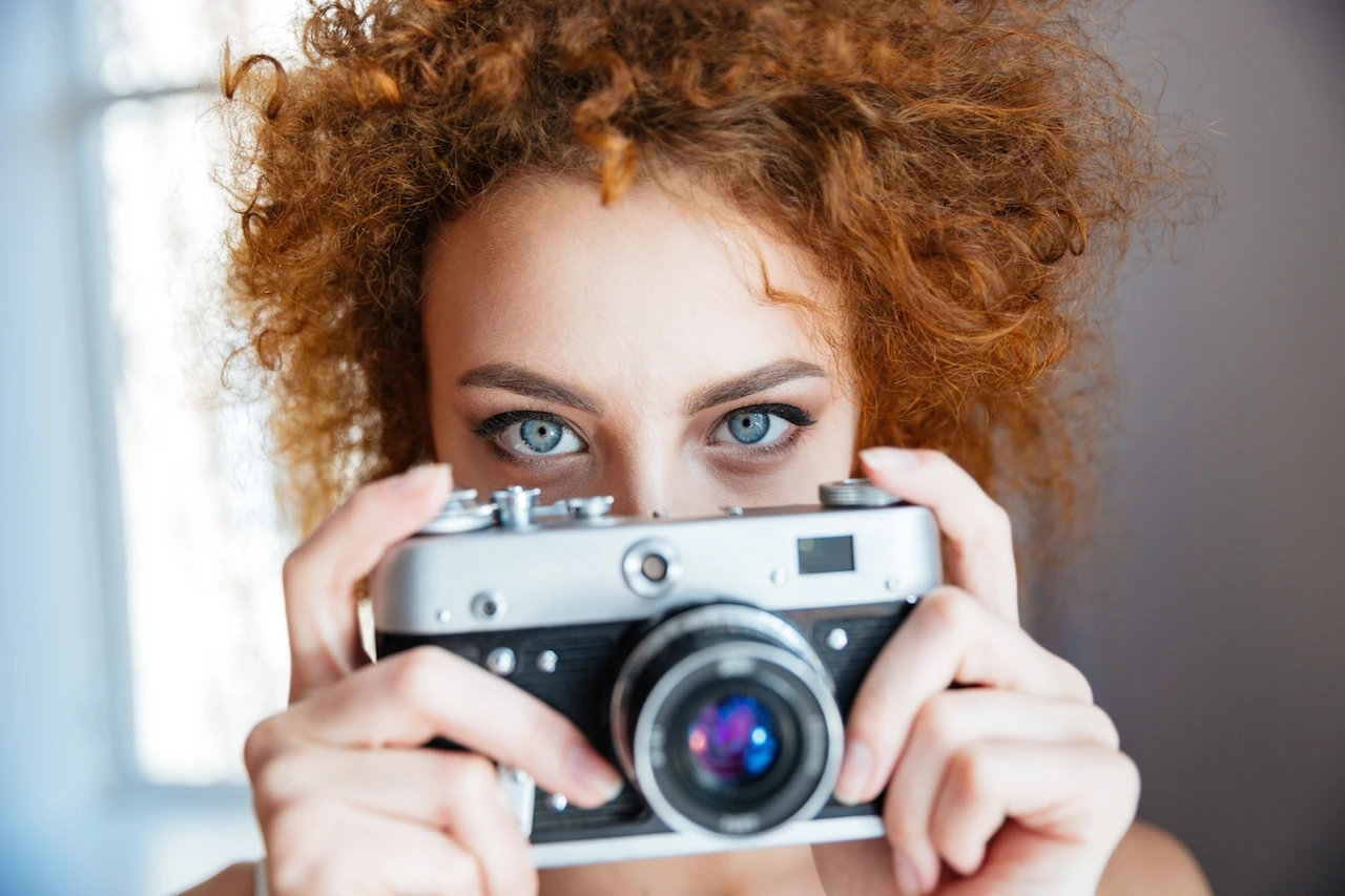 attractive-redhead-woman-photographer-using-old-P7KCK33.JPG