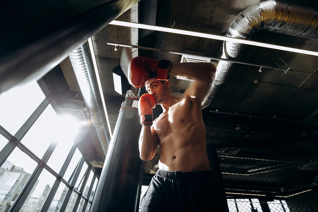 sportsman-in-red-boxing-gloves-with-a-naked-torso--9FGRHMW.JPG