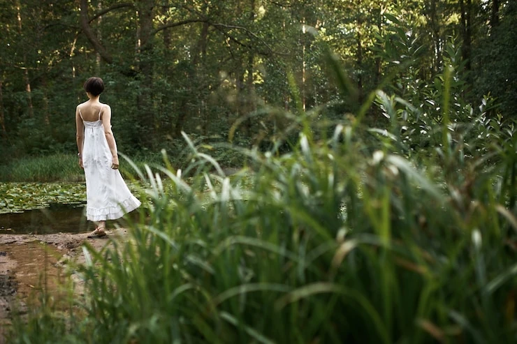 outdoor-summertime-image-romantic-adorable-young-female-wearing-long-white-dress-relaxing-wild-nature-alone-weekend-standing-by-pond-background-with-fresh-green-grass-foreground_343059-2124.jpg?semt=ais_country_boost&w=740