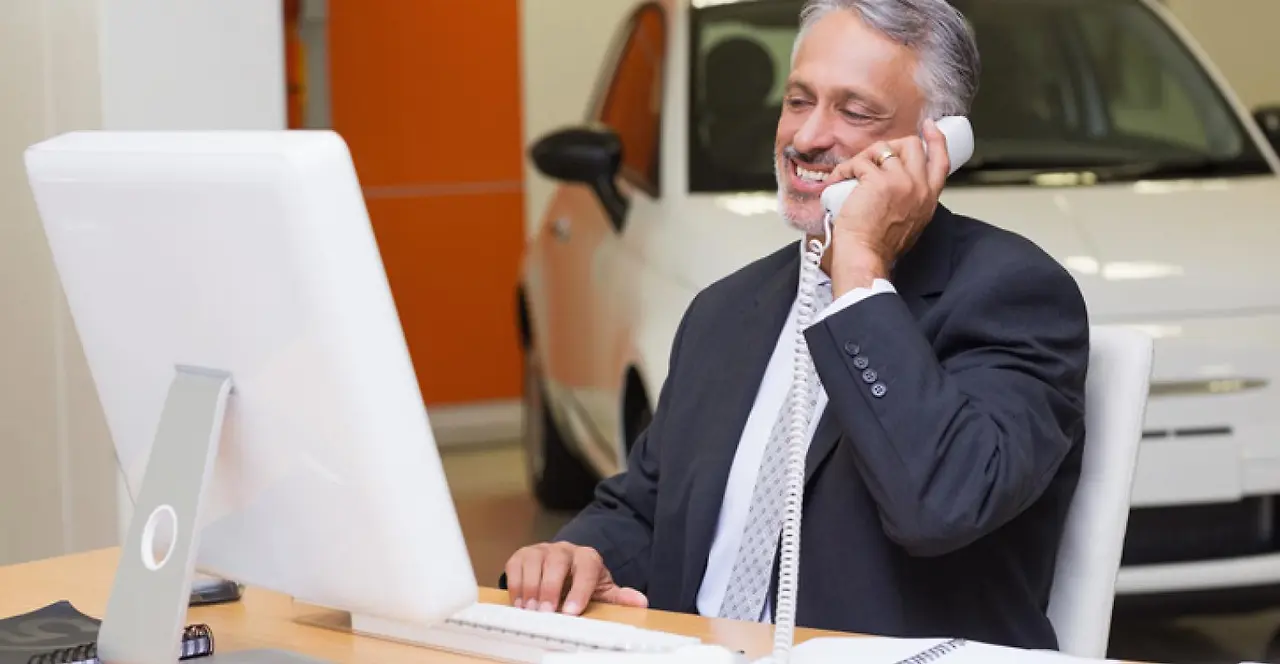 Dealer%20-%20on%20phone%20at%20car%20dealership.jpg?itok=ZwcrVVrN