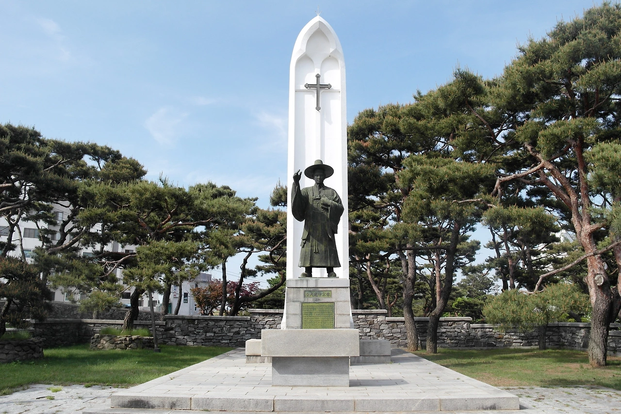 사진2-소나무 숲에 자리한 성 김대건 안드레아 신부 동상..JPG