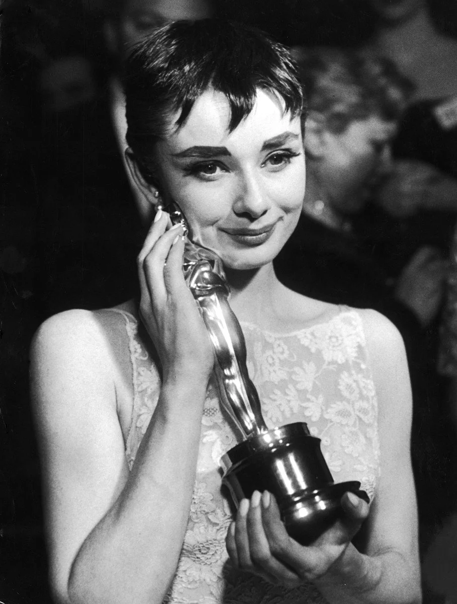 -audrey-hepburn-affectionately-holding-oscar-award-she-won-for-her-performance-in-the-movie-roman-holiday-at-the-academy-awards-ceremony-in-new-york-city-photo-by-ralph-morsethe-life-picture-collectio.jpeg?type=w1200