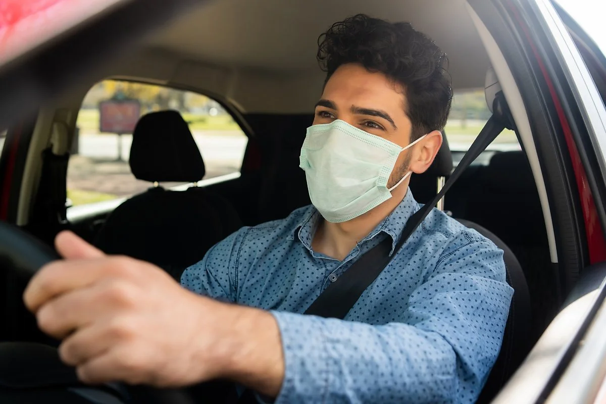 portrait-young-man-using-face-mask-while-driving-his-car-his-way-work-transport-concept-new-normal-lifestyle-concept.jpg?type=w1200