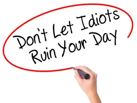 63292884-women-hand-writing-don-t-let-idiots-ruin-your-day-with-black-marker.jpg?type=w773