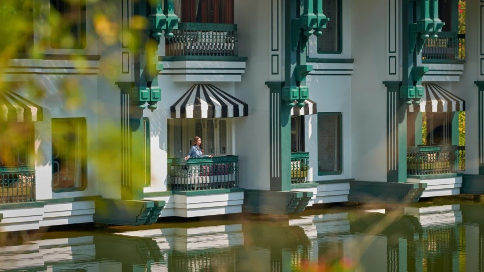 A-woman-stands-on-the-King-Classic-Lake-View-balcony-at-Khao-Yai-resort-scal.jpg?type=w966