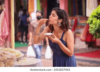 woman-eating-indian-snack-pani-260nw-2453037443.JPEG