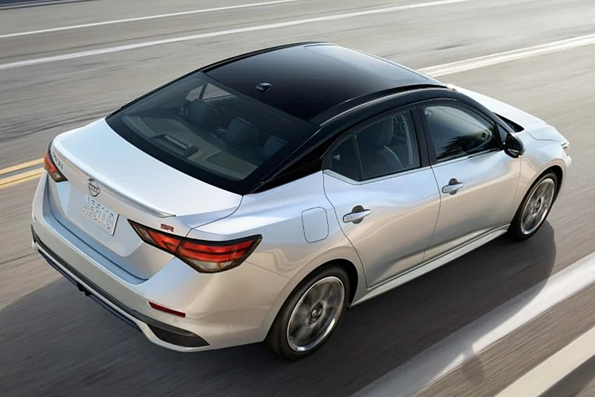 2025-nissan-sentra-seen-from-above-driving-swiftly-highway-ocean-background.jpeg