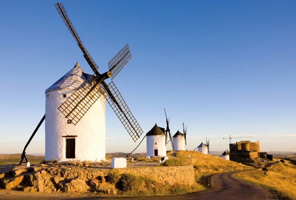 MAN32853_Windmills_on_a_hillside_with_a_castle_in_background._Consuegra__Cas.jpg?type=w966