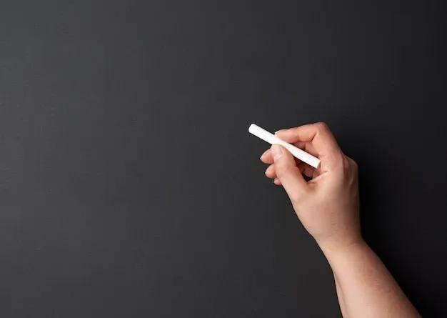 Premium Photo _ Hand holds a piece of white chalk on the background of an empty black chalk board.jpeg