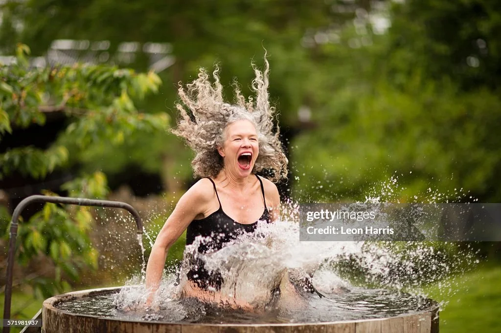 mature-woman-splashing-into-fresh-cold-water-tub-at-eco-retreat.jpg?s=1024x1024&w=gi&k=20&c=i3M4oSxyN4ziFFQn_vgQpap6uqGOYz-5FpgB2orj9p0=