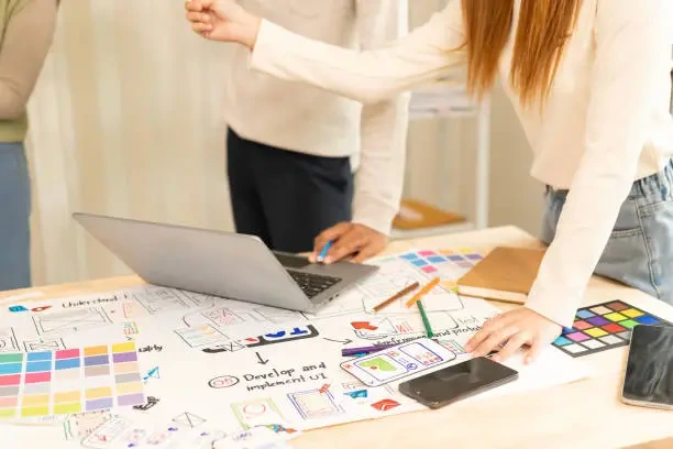 a-team-of-ui-ux-web-designers-is-working-together-to-develop-a-mobile-responsive-website-with.webp?a=1&b=1&s=612x612&w=0&k=20&c=7s1rGJ2YBZ8gAbD7Su7eQ4Y9XOxTYS3tNGaGrRfLyE4=