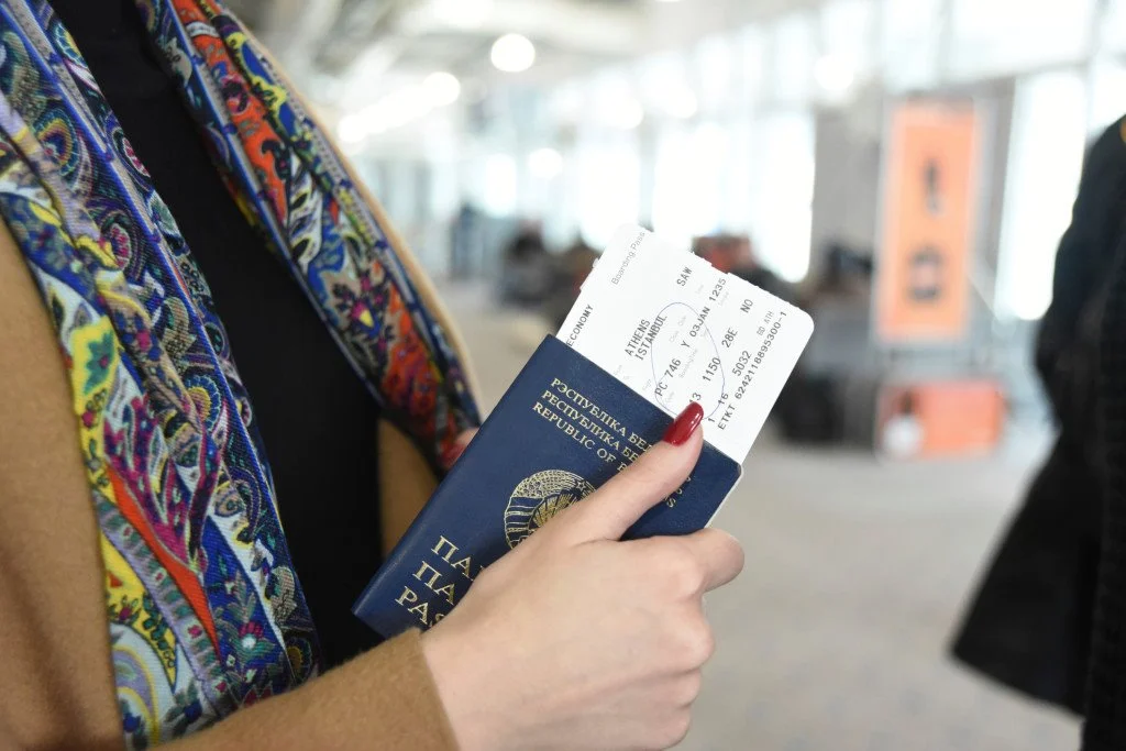 woman-with-passport-and-visa-537368613.jpg?type=w1200