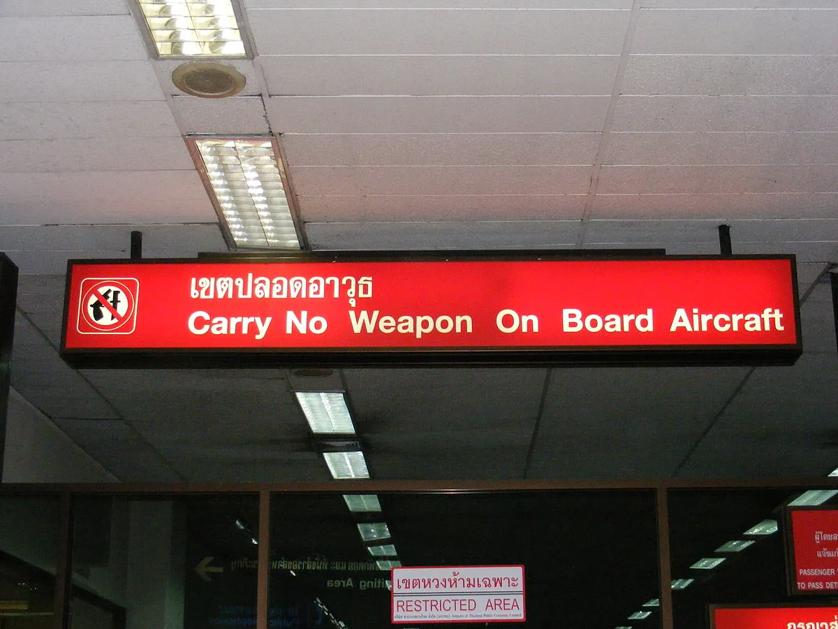 Don_Mueang_Airport_sign_-_Carry_No_Weapon_on_Board_Aircraft.JPG