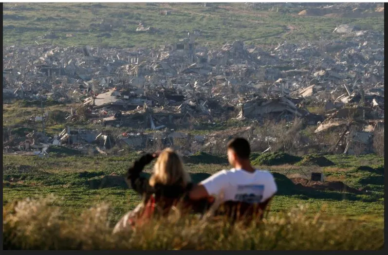 24 02 2026 Israelis sitting near the Israeli side of the Israel-Gaza border look at rubble from destroyed buildings in Gaza, in Israel, February 4..JPG
