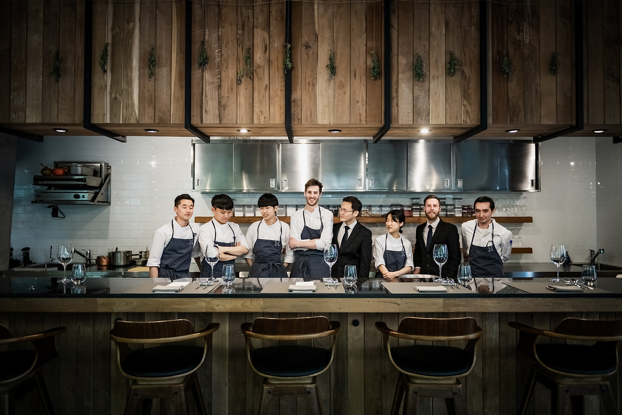 Australian chef Joseph Lidgerwood (pictured centre) of EVETT receives the 2021 MICHELIN Young Chef Award