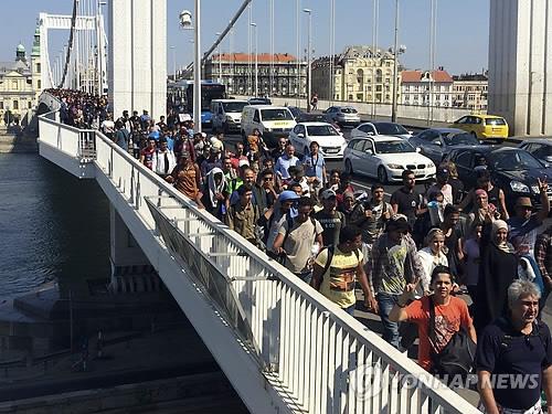 걸어서 오스트리아로…기차편 막힌 헝가리 도착 난민들   (부다페스트 AP=연합뉴스) 헝가리에 와 있는 난민 수백명이 4일 걸어서 오스트리아로 가겠다며 헝가리 부다페스트에서 다뉴브 강을 건너가고 있다. 부다페스트 켈레티 역에는 국제선 열차 탑승이 막힌 난민 수천명이 농성 중이다. ciy@yna.co.kr