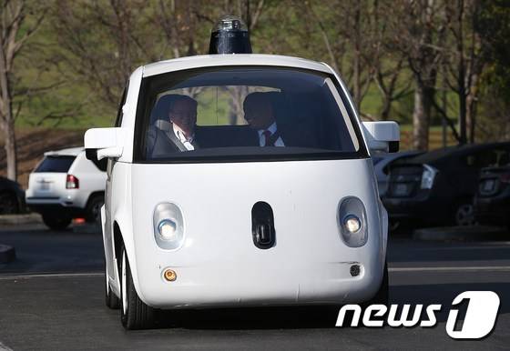 지난해 2월 2일 미국 캘리포니아주에서 구글 자율주행차에 탑승한 에릭 슈미트 현 알파벳 회장(왼쪽)과 앤토니 폭스 미 교통부 장관. © AFP=뉴스1