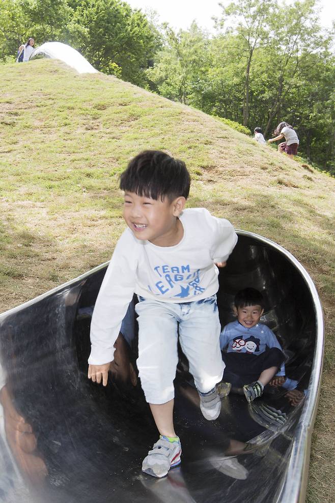 언덕 속 미끄럼틀을 타고 내려온 아이들의 모습이 천진난만합니다. 다른 동네에서 놀러온 아이들은 "우리 동네 놀이터는 재미 없는데…"라며 기적의 놀이터를 부러워합니다. 사진 프리랜서 오종찬