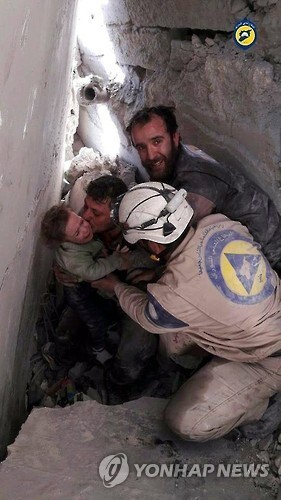 2016년 시리아 알레포에서 하얀헬멧 대원이 무너진 잔해 속에서 어린이를 구조하는 모습 [EPA/SYRIA CIVIL DEFENCE=연합뉴스 자료사진]