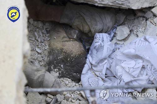 11일 시리아 알레포 반군지역에서 시리아군의 폭격으로 무너진 건물 더미 사이로 소녀의 모습이 보인다. [AP=연합뉴스]