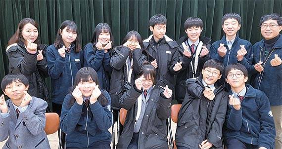 대구 새론중학교 시청각실에서 학생들이 방한용 패딩과 재킷을 입고 활짝 웃고 있다. [대구 새론중]