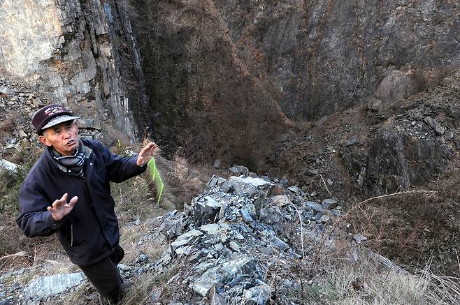 충남지역에 있는 한 석면 폐광에 대해 지역주민이 설명하고 있다. [중앙포토]