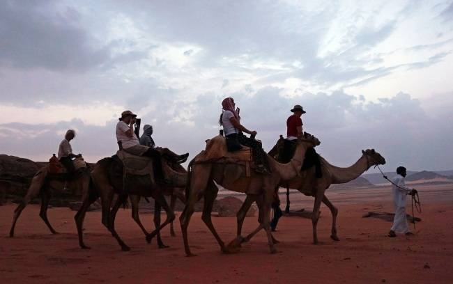 낙타를 타고 와디럼 사막을 투어하는 관광객들.