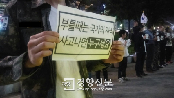 14일 밤 서울 종로구 동아일보사 앞에서 열린‘예비군과 병사 처우개선을 요구하는 집회’에 참가한 한 남성이 손팻말을 들고 있다. / 김원진 기자