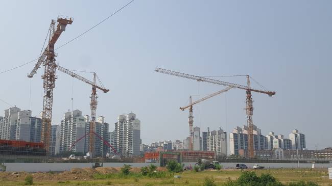 9일 경기도 시흥시 은계지구 공사 현장 뒤로 기존 아파트들과 학교 건물이 보인다. 은계지구는 2018년에 소사원시선 대야역과 신천역이 생겨 교통망이 우수하고 구도심과 닿아있어 인프라를 공유할 수 있는 점이 장점으로 꼽힌다.